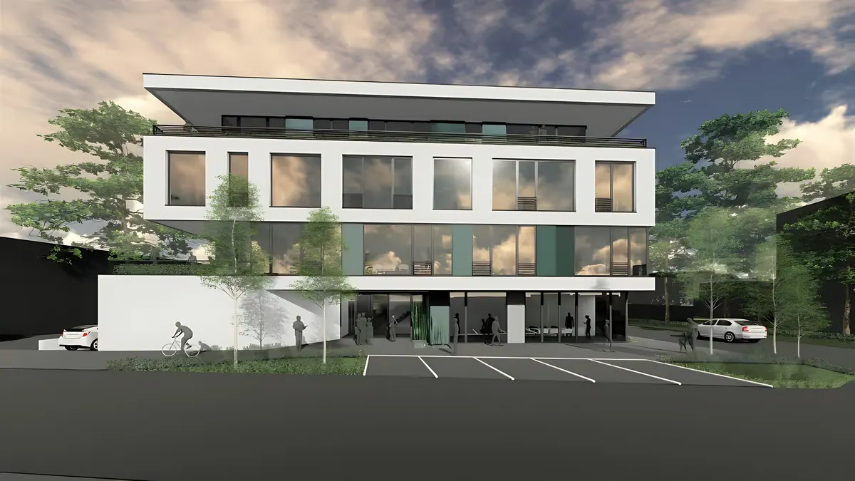 Front view with large areas of glass and parking spaces outside